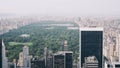 Aerial photo of Central Park with a lot of high-rise buildings and trees covered in fog