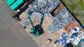 Crane with a huge claw in front of a steel scrap heap Royalty Free Stock Photo