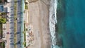 Aerial photo of a desolate stretch of sandy beach during tumultuous waves pounding the shore Crazy beauty turquoise