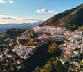 Aerial photo distant view charming Mijas pueblo, typical Andalusian white-washed mountain village, houses rooftops, small town Royalty Free Stock Photo