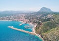 Aerial photo drone point of view coastal town of Javea with green mountains, turquoise bay Mediterranean Sea