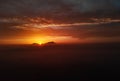 Aerial photo drone point of view horizon over land and glowing bright sunlight through mountains