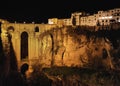 Aerial photo drone point of view huge gorge and ancient architecture, city street lights night view of Ronda in Spanish province Royalty Free Stock Photo