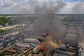 Aerial photo of a fire at a car junk yard firefighters water hosing flames extinguishing