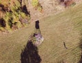 Aerial photo of hunting post and drone pilot with long shadows at the forest clearing on the Japetic mountain, Croatia Royalty Free Stock Photo