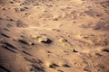 The aerial photo of a jeep and wheel tracks in desert