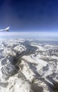 Aerial photo of the landscape with clouds, snowy mountains and view stretching all the way to the horizon