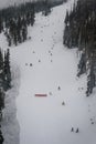 Skiers and snowboarders going down slopes of Whistler Blackcomb