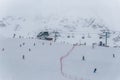 Skiers and snowboarders going down slopes of Whistler Blackcomb