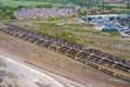 Aerial photo of a lot of hopper car / hopper wagon old rusty train cargo trucks on train tracks located in the town of York in