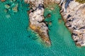 Aerial photo over granite rocky coastline Mediterranean crystal clear blue sea water. Aerial photo of ocean waves hitting rocky Royalty Free Stock Photo