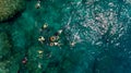 Aerial photo of people snorkeling in tropical Coral reef