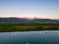 Aerial photo of perfect blue water, sunset sky and boats docked Royalty Free Stock Photo