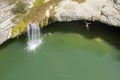 An aerial photo of a person jumping into a lake, Zarecki krov, Pazin, Istria, Croatia