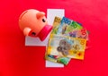 Aerial photo of a piggy bank on top of a wad of swiss bills on a swiss flag.Swiss currency, Swiss franc Royalty Free Stock Photo