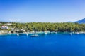 Aerial photo of sailing boats docked in blue bay of Fiskardo, Kefalonia island, Ionian, Greece Royalty Free Stock Photo