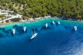 Aerial photo of sailing boats docked in blue bay of Fiskardo, Kefalonia island, Ionian, Greece Royalty Free Stock Photo