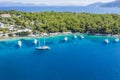 Aerial photo of sailing boats docked in blue bay of Fiskardo, Kefalonia island, Ionian, Greece Royalty Free Stock Photo