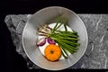 Aerial photo of a saucepan with vegetables on a stone slab. Royalty Free Stock Photo