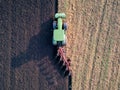 Aerial photo of a tractor ploughing a field in a countryside Royalty Free Stock Photo