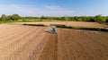 Tractor ploughing a field in the french countryside Royalty Free Stock Photo