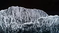 Aerial photo of waves on black sand beach. Royalty Free Stock Photo
