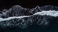 Aerial photo of waves on black sand beach. Royalty Free Stock Photo