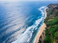 Aerial photo of a wild beach in Bali. A long strip of beach and a steep mountain slope covered with greenery. Wild beach in Bali Royalty Free Stock Photo