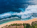 Aerial photo of a wild beach in Bali. A row of sun umbrellas on the beach. Wild beach in Bali with yellow sand and clear turquoise Royalty Free Stock Photo