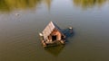 Aerial photo of the wild ducks at the wooden floating hut on the river Royalty Free Stock Photo