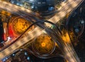 two large overhead picture of freeway intersection at night with traffic moving