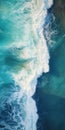 Vibrant Aerial Shot Of Blue Ocean Waves Crashing Into Coast