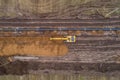 Aerial photograph of the laying pipe of large diameter in clay soil. Autumn