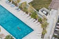 Aerial photograph of man swimming in pool with blue water