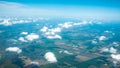 Aerial photograph of a pattern of fields, valleys and villages with cloud sky taken out of an aeroplane