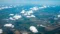 Aerial photograph of a pattern of fields, valleys and villages with cloud sky taken out of an aeroplane