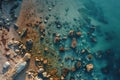 This aerial photograph showcases a beach adorned with rocks and bordered by crystal-clear water, Immersive aerial view of a wild