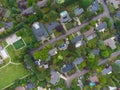 Aerial photograph. Small green town, roofs of small houses, neat lawns, many trees, paved roads. The beauty of nature, tourism,