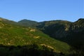 Aerial photography of green mountains panoramic picturesque view from drone foreshortening in clear weather day time with blue sky