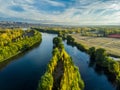 Aerial photography of a valley in autumn. The yellow color is observed in the vegetation, there is a large river divided in two.