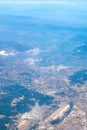 Aerial photography. View from the plane window: from a great height below you can see mountains and green fields. Royalty Free Stock Photo