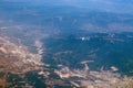 Aerial photography. View from the plane window: mountains and green fields. Travel and tourism concept. Royalty Free Stock Photo