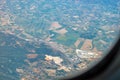 Aerial photography. View from the plane window: mountains and green fields. Travel and tourism concept Royalty Free Stock Photo