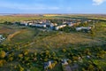 Aerial photography, a working village among the steppe fields in the light of the setting sun