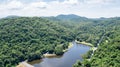 Aerial picture from drone: Tropical forest with reservoir Royalty Free Stock Photo