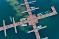 Aerial picture of floating dock with boats, motorboats and vessels floating on water in lake Small Prespes Royalty Free Stock Photo