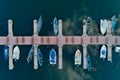 Aerial picture of floating dock with boats, motorboats and vessels floating on water in lake Small Prespes Royalty Free Stock Photo