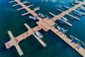 Aerial picture of floating dock with boats, motorboats and vessels floating on water in lake Small Prespes Royalty Free Stock Photo