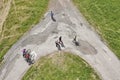 Aerial picture of people walking on a dirt road.
