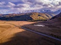 The drone picture of the scenic road in the snow-capped Altai Mountains (Chui tract) in Siberia, Russia. Royalty Free Stock Photo